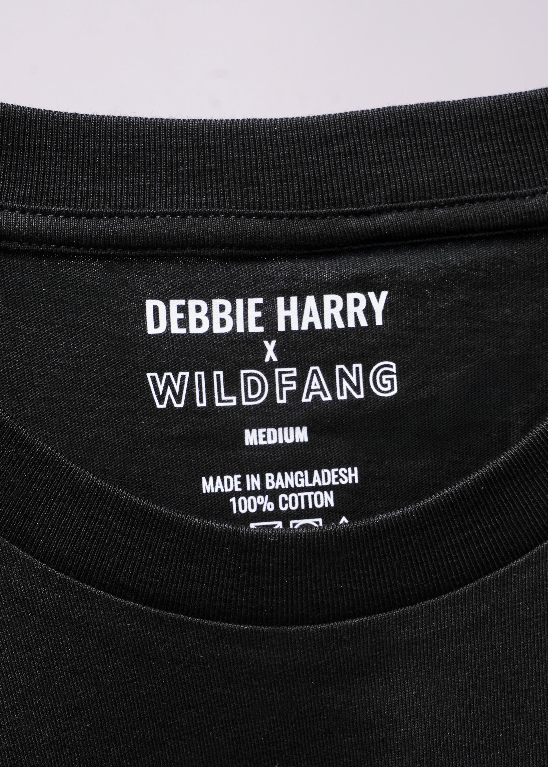 Close up of black tee label that reads DEBBIE HARRY X WILDFANG