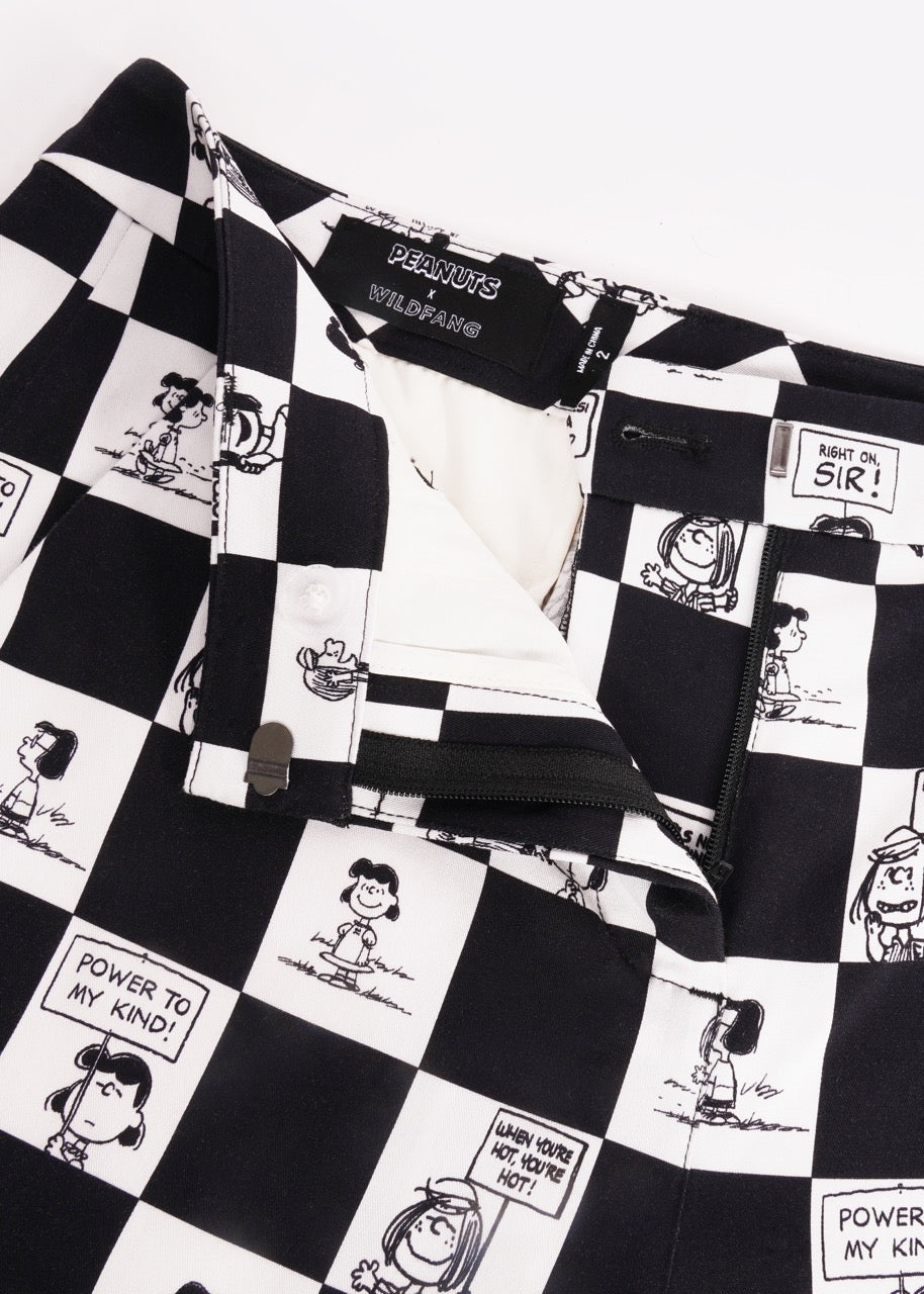 S=Close up of the waist and button closure of the checkered black and white Slim Crop Pant from the Peanuts x Wildfang collection as it lays flat on a white background.