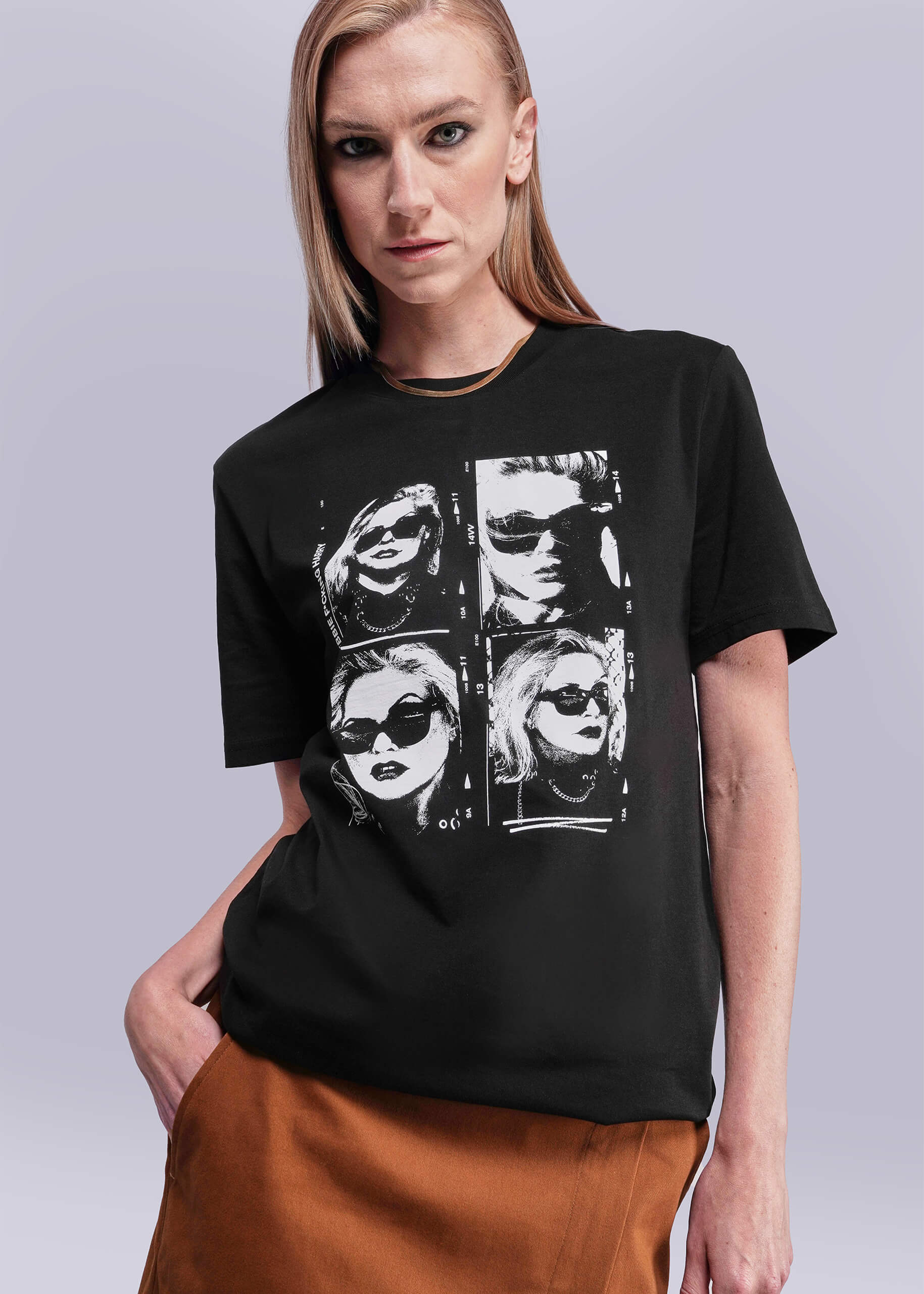 S=Person wearing a black t-shirt with graphic design on a plain background