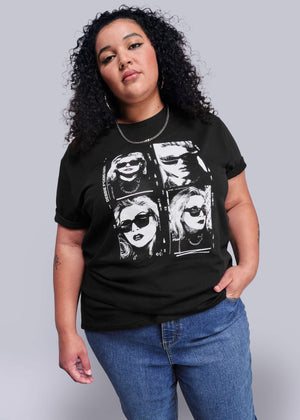 1X=Person wearing a black t-shirt with graphic design on a plain background