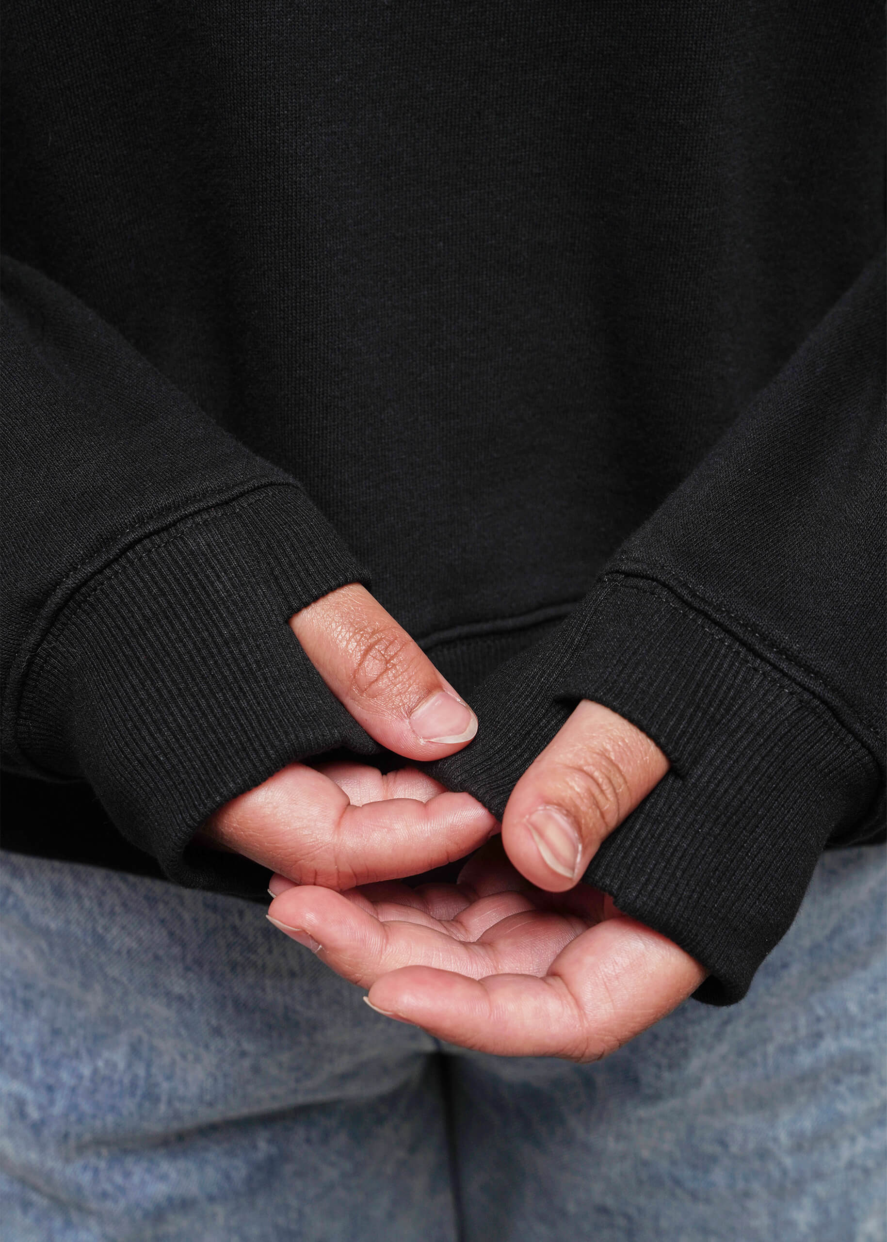 S=Close up of sweatshirt thumb holes
