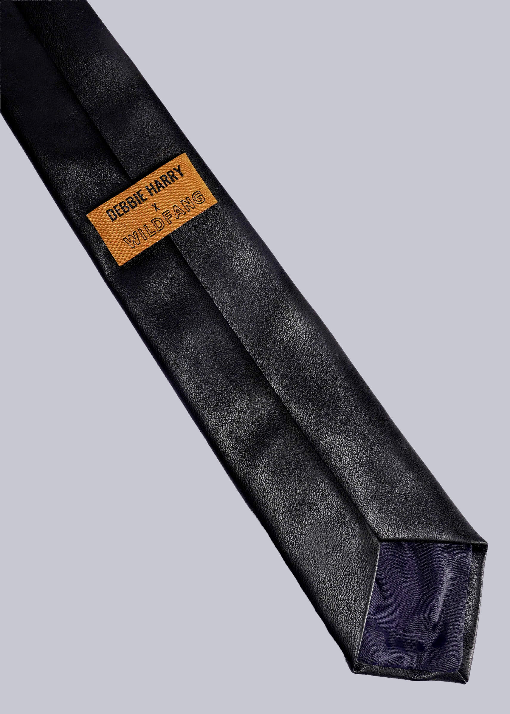 Black tie with a yellow label on a light gray background