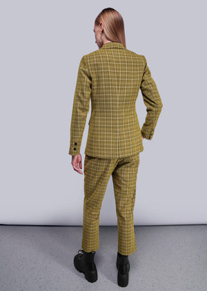 S=Back view of person wearing a yellow plaid suit against a plain background
