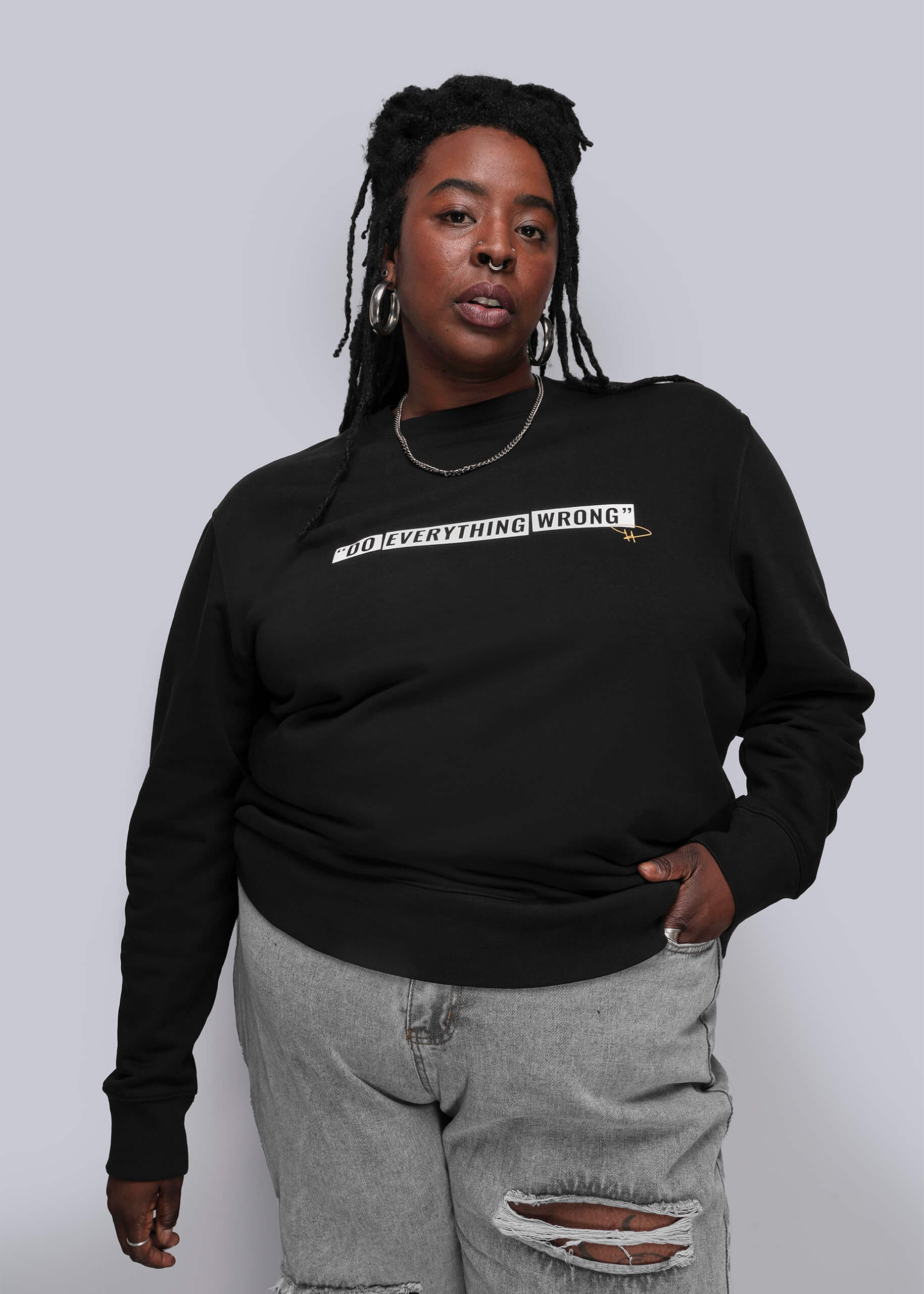 1X=Person wearing a black sweatshirt with text on a plain background