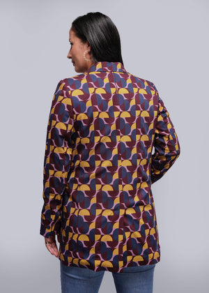 S=Woman wearing a patterned shirt with a plain background