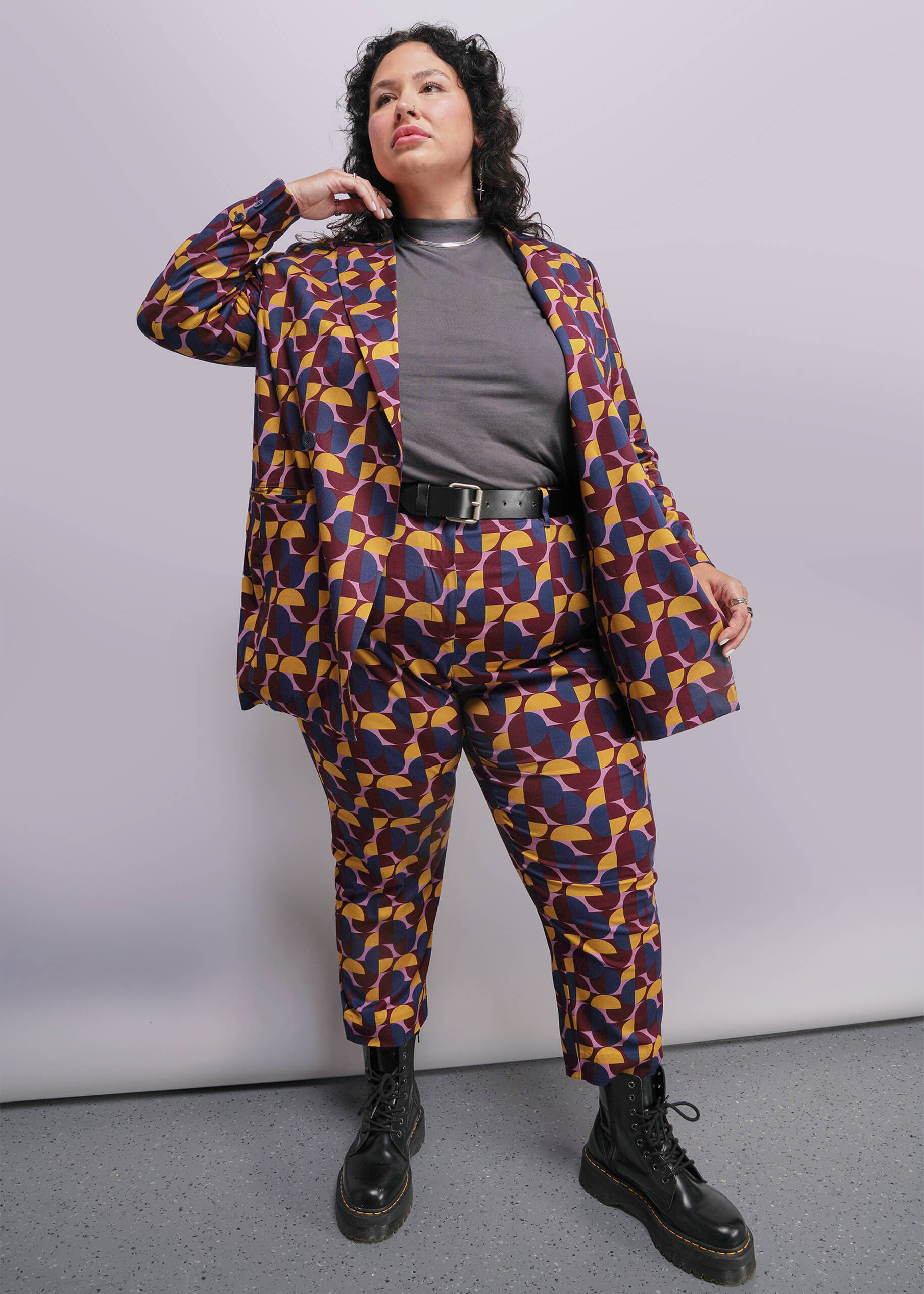 1X=Person wearing a patterned suit with a plain background
