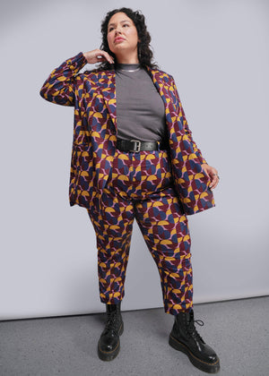 1X=Person wearing a patterned suit with a plain background