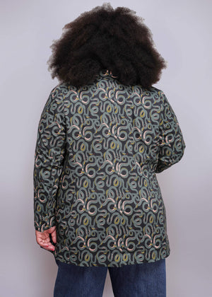 1X=Person wearing a patterned coat with a white background