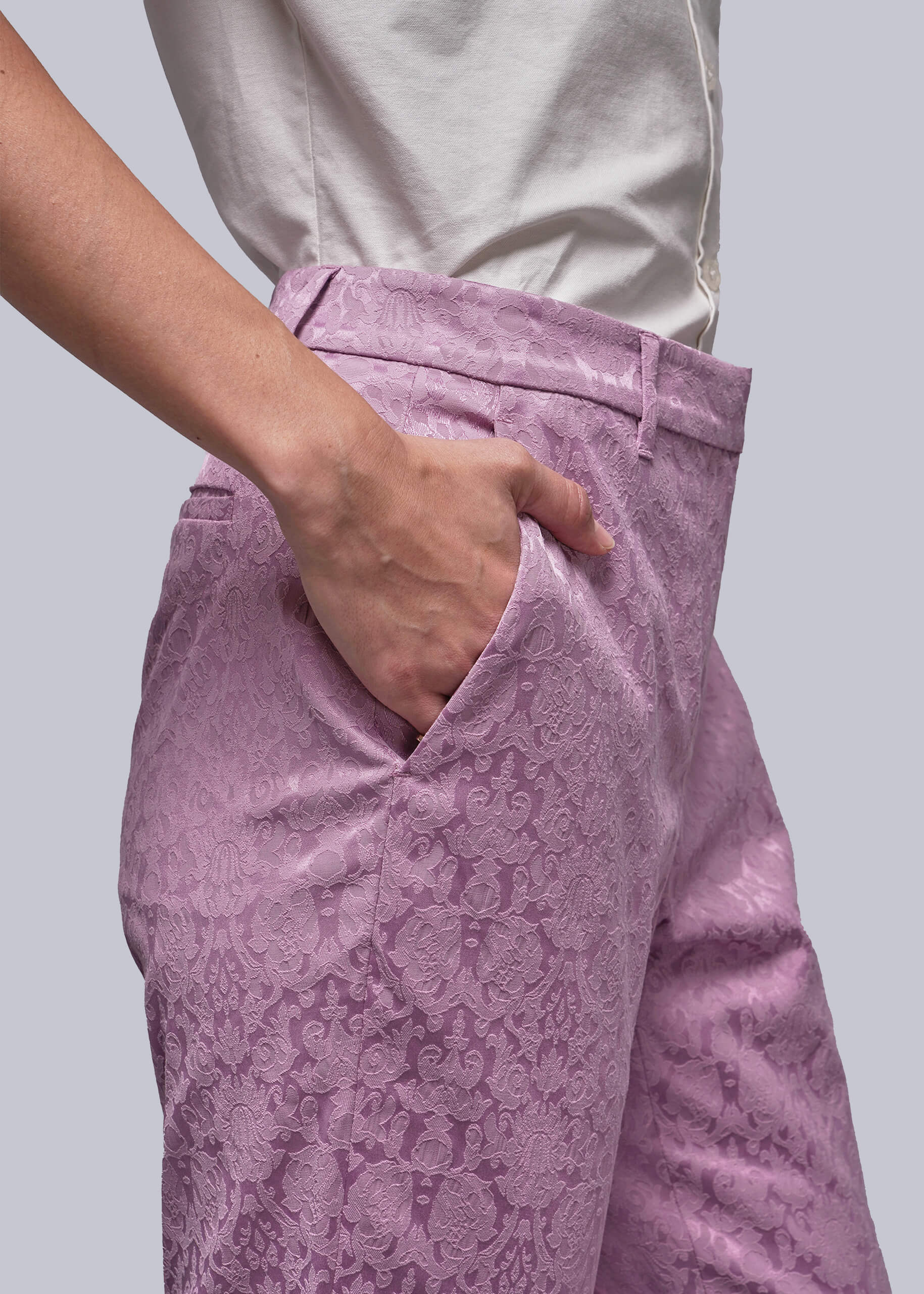 S=Person wearing pink patterned pants with a plain background