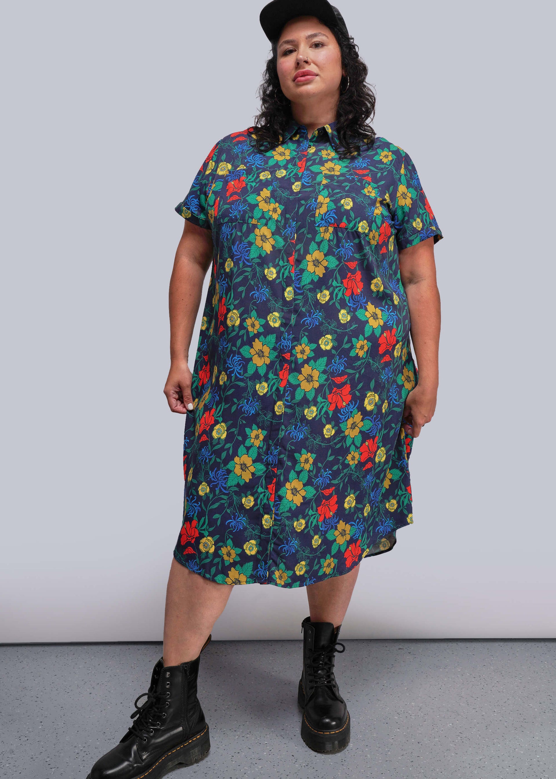 1X=Person wearing a colorful floral dress with a plain background