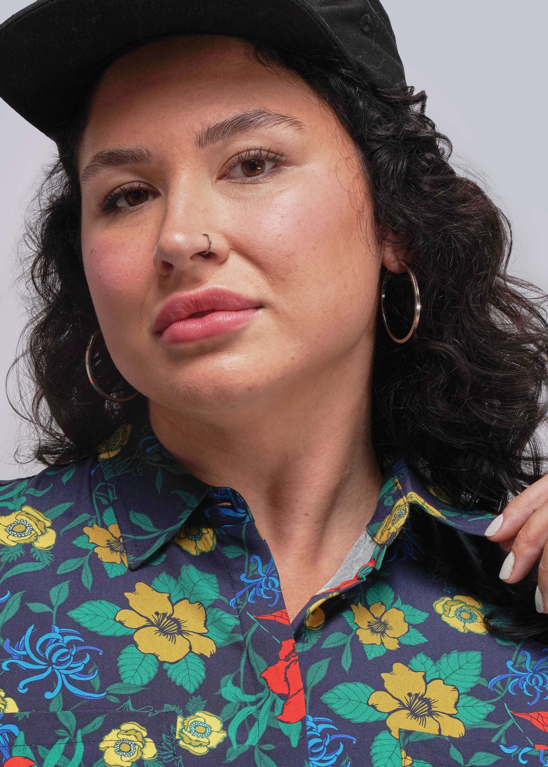 1X=Close up of person wearing a colorful floral dress to show collar with a plain background