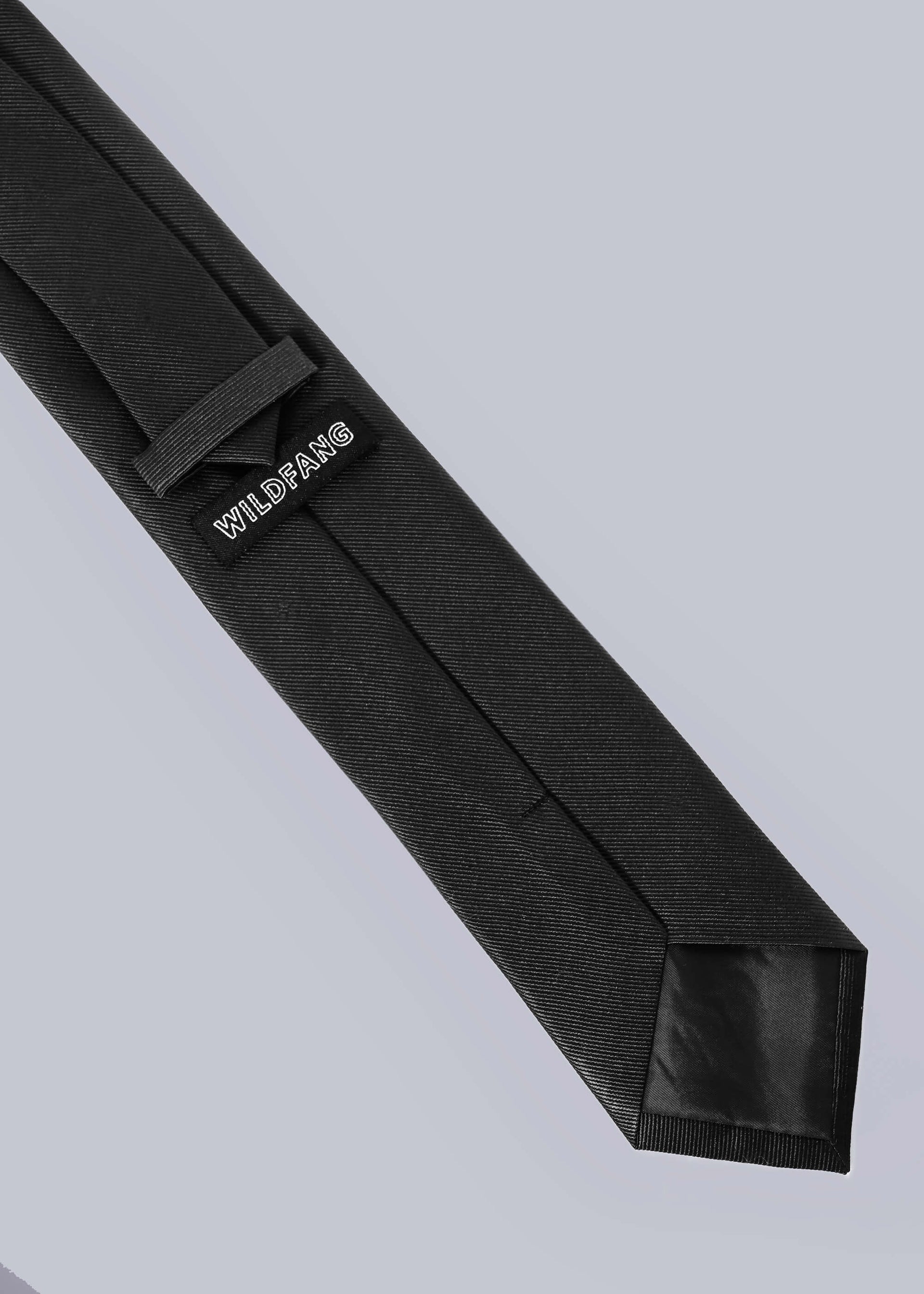 Back of black tie on white background showing WILDFANG label.