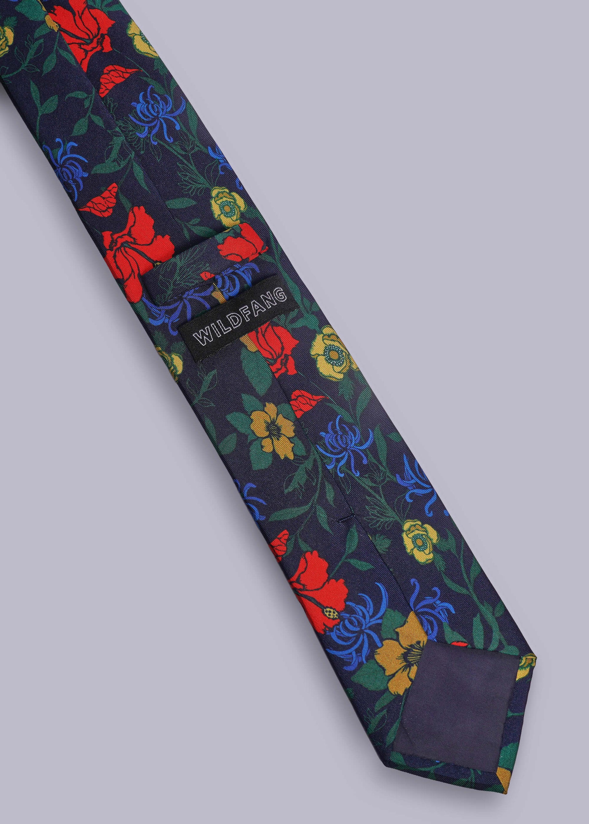 Floral patterned tie with visible brand name on a light gray background