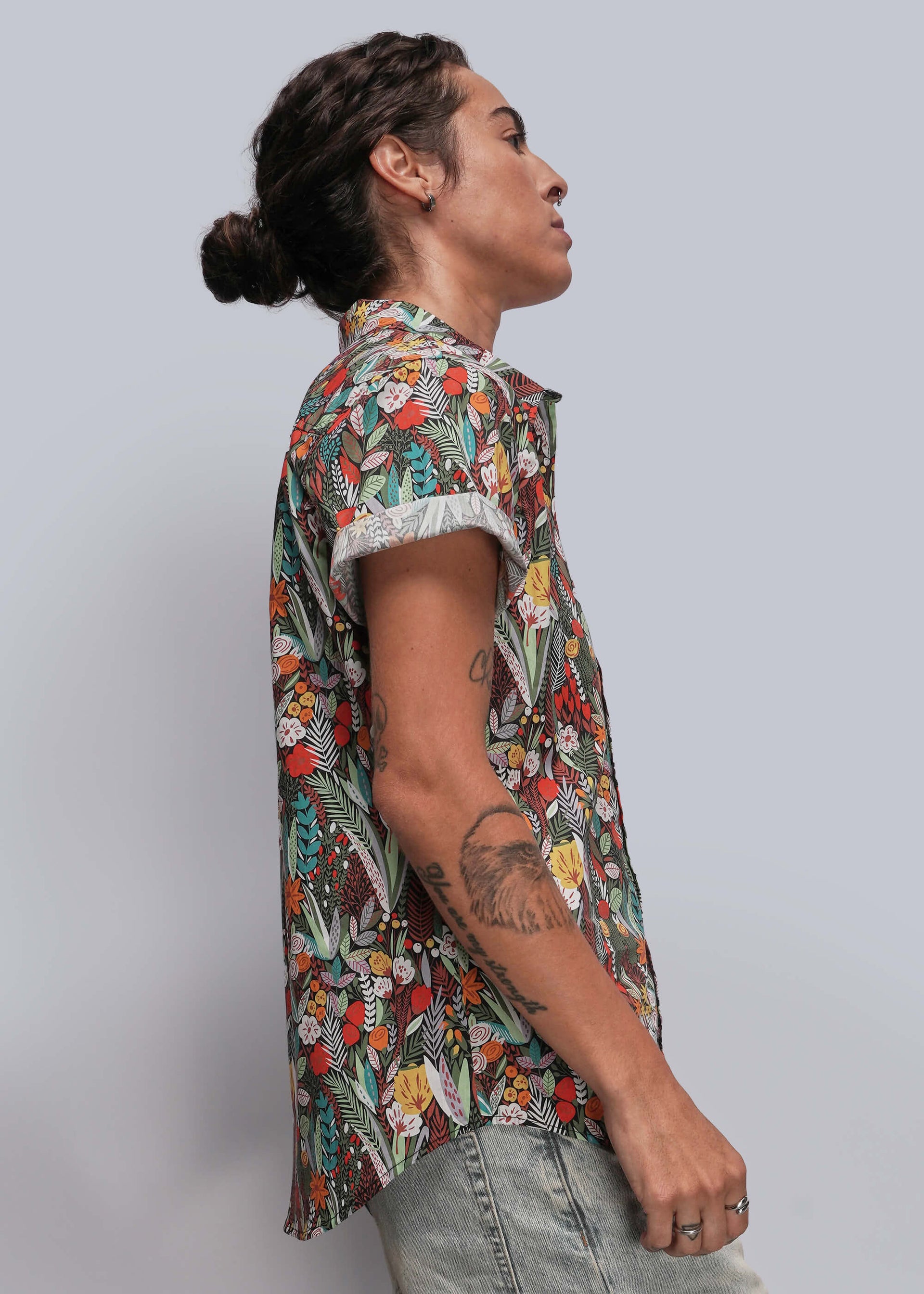 S=Person wearing a colorful floral shirt against a plain background