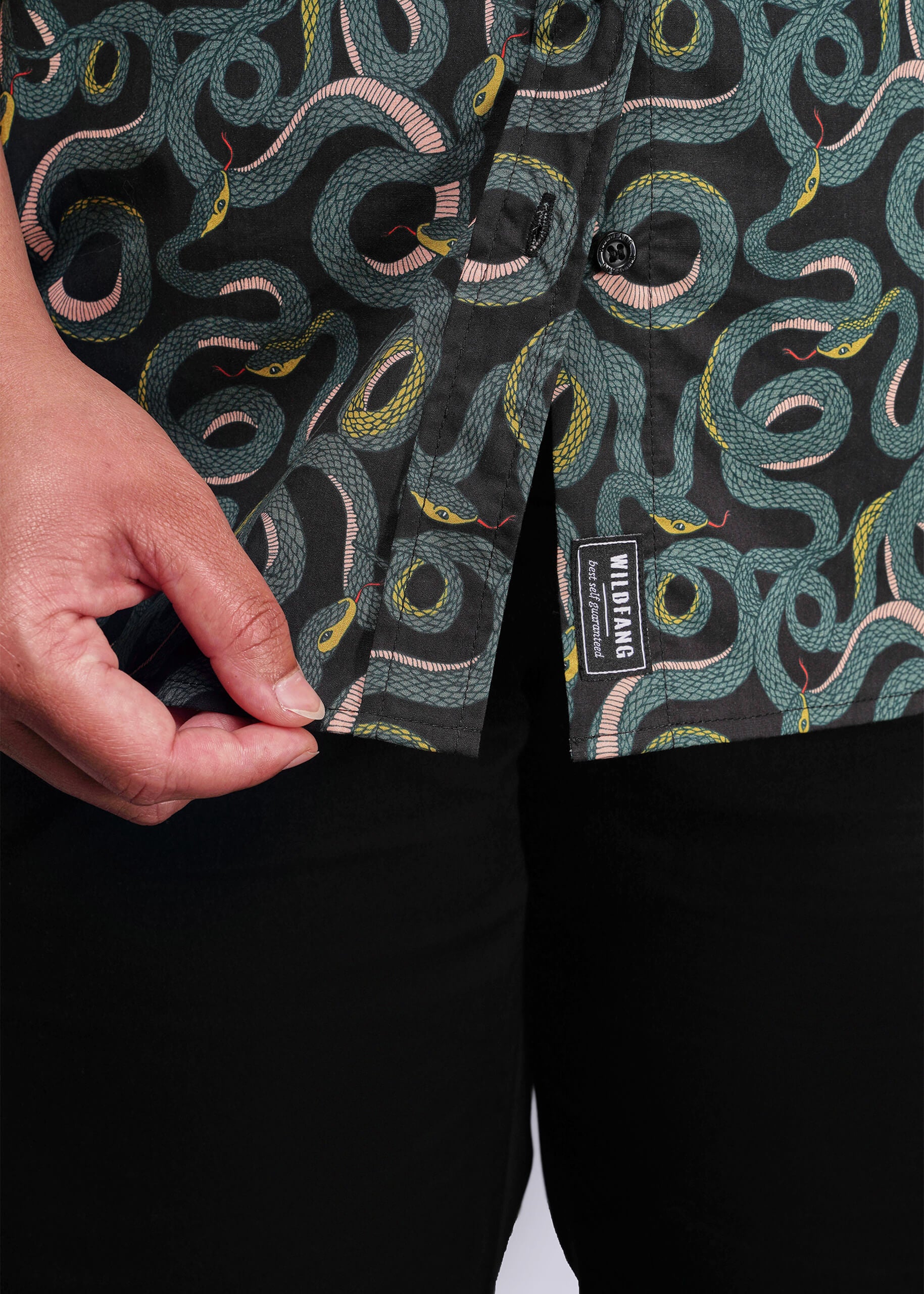 1X=Close-up of a shirt with snake pattern and a visible brand label.