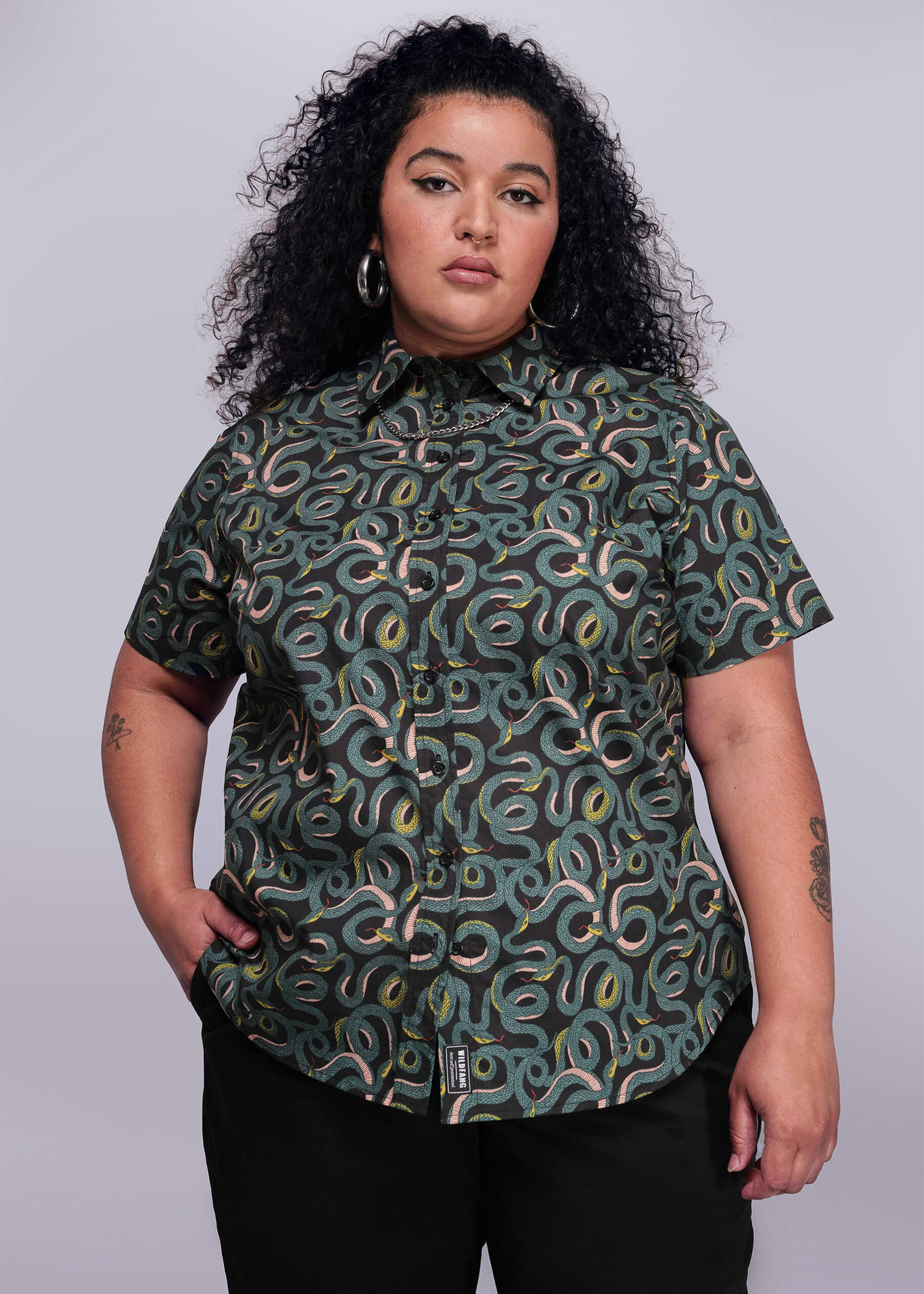 1X=Person wearing a patterned shirt against a plain background