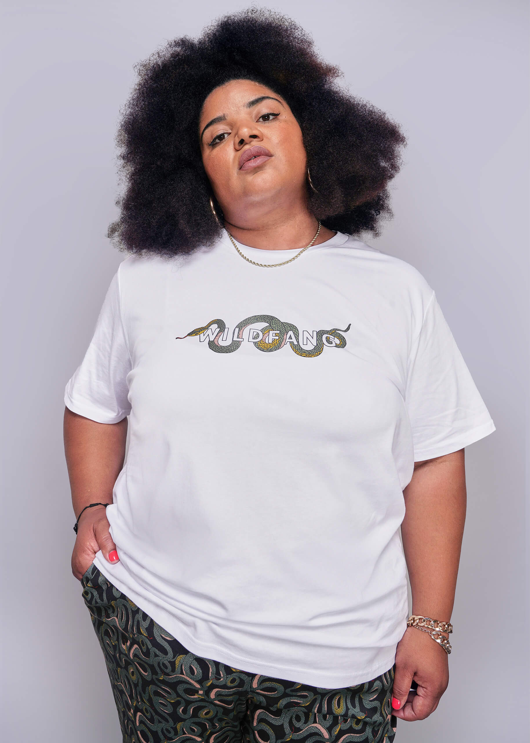 1X=Person wearing a white t-shirt with a graphic design on a plain background