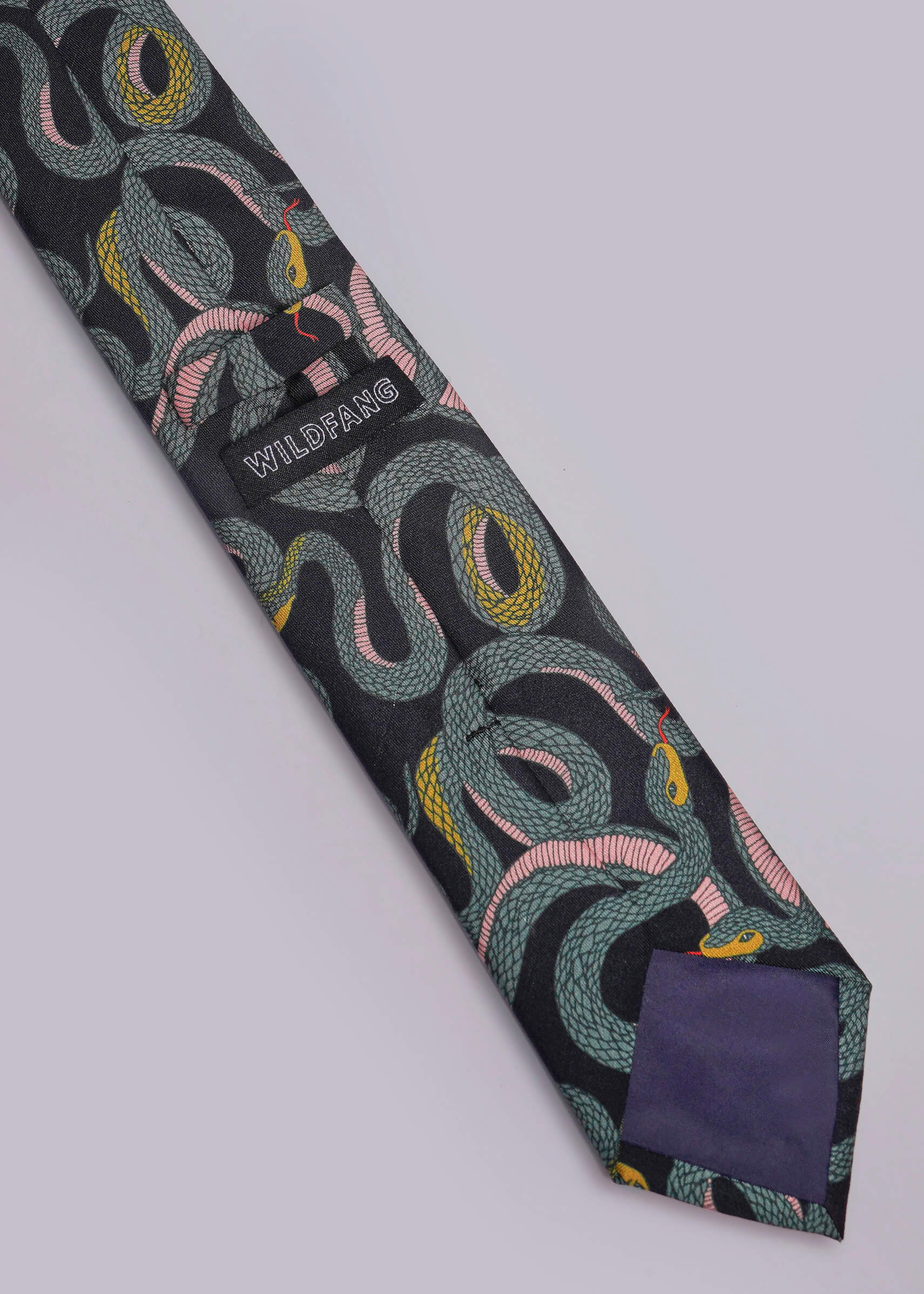 Patterned tie with a pocket square on a light gray background