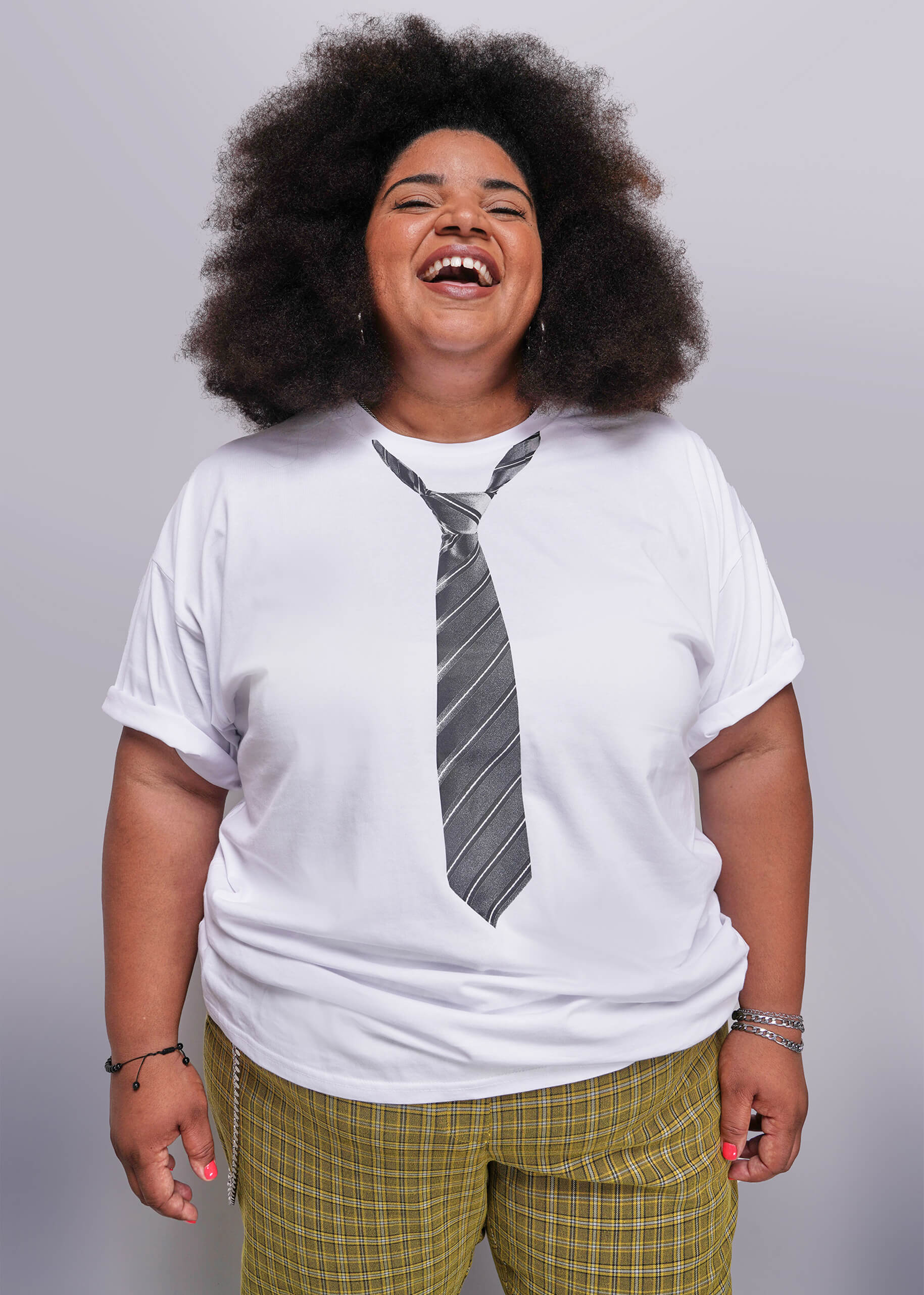 1X=Person wearing a white t-shirt with a tie design on a plain background