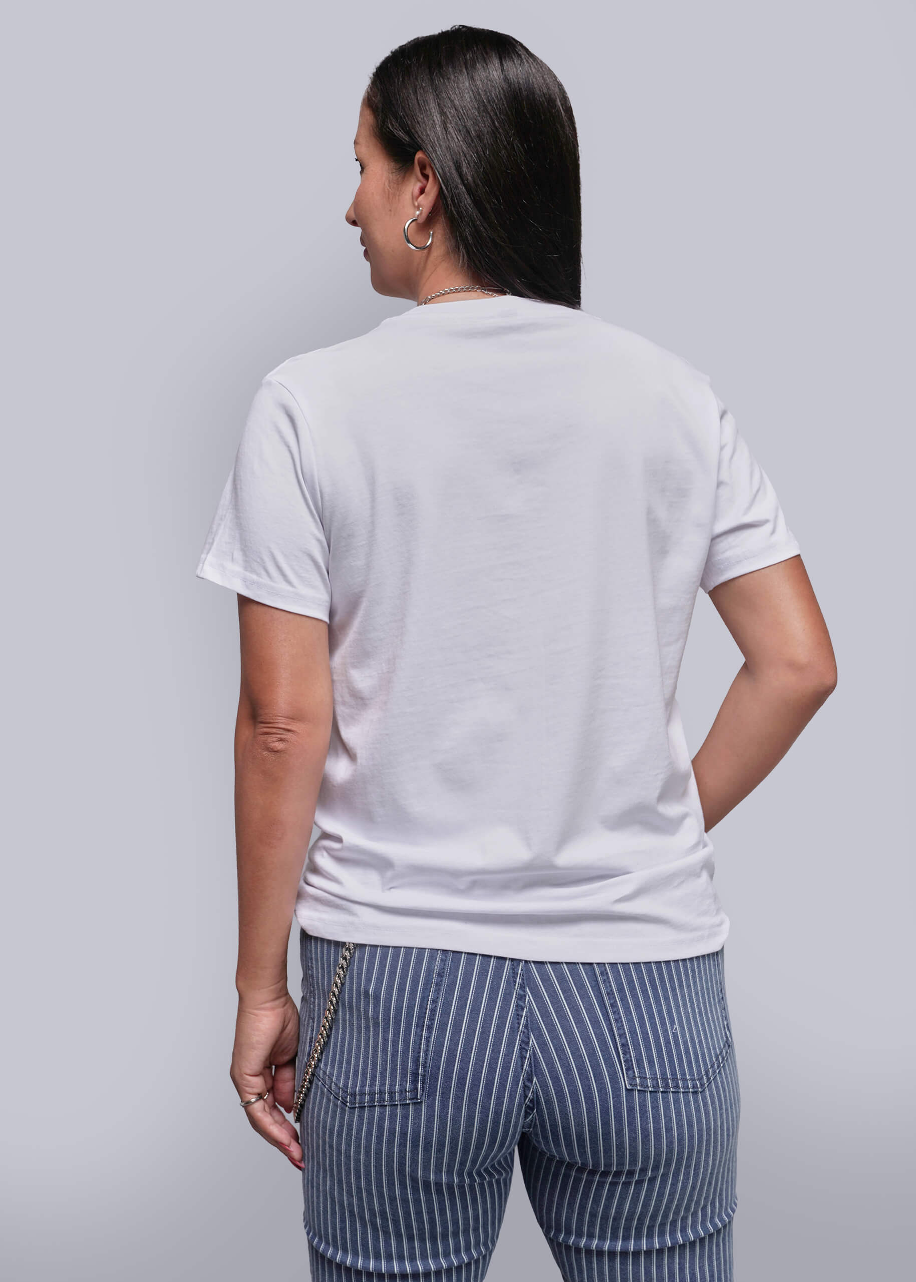 S=Person wearing a plain white t-shirt and striped pants on a light gray background