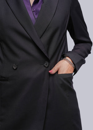 S=Black blazer with a hand in the pocket on a gray background