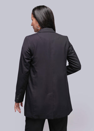 S=Person wearing a black blazer from behind on a light gray background