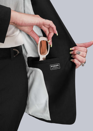 S=Person placing sunglasses in an inside blazer pocket