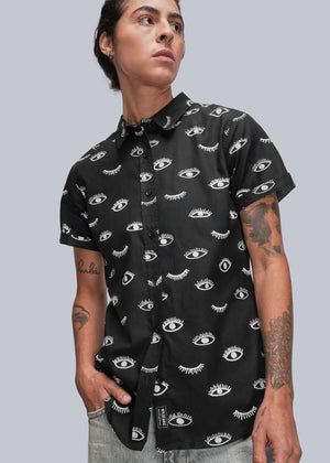 S=Person wearing a black short-sleeve shirt with white pattern against a gray background