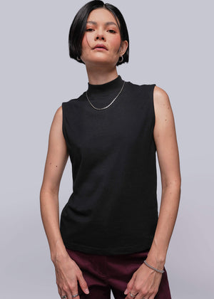 S=Person wearing a black sleeveless top against a plain background