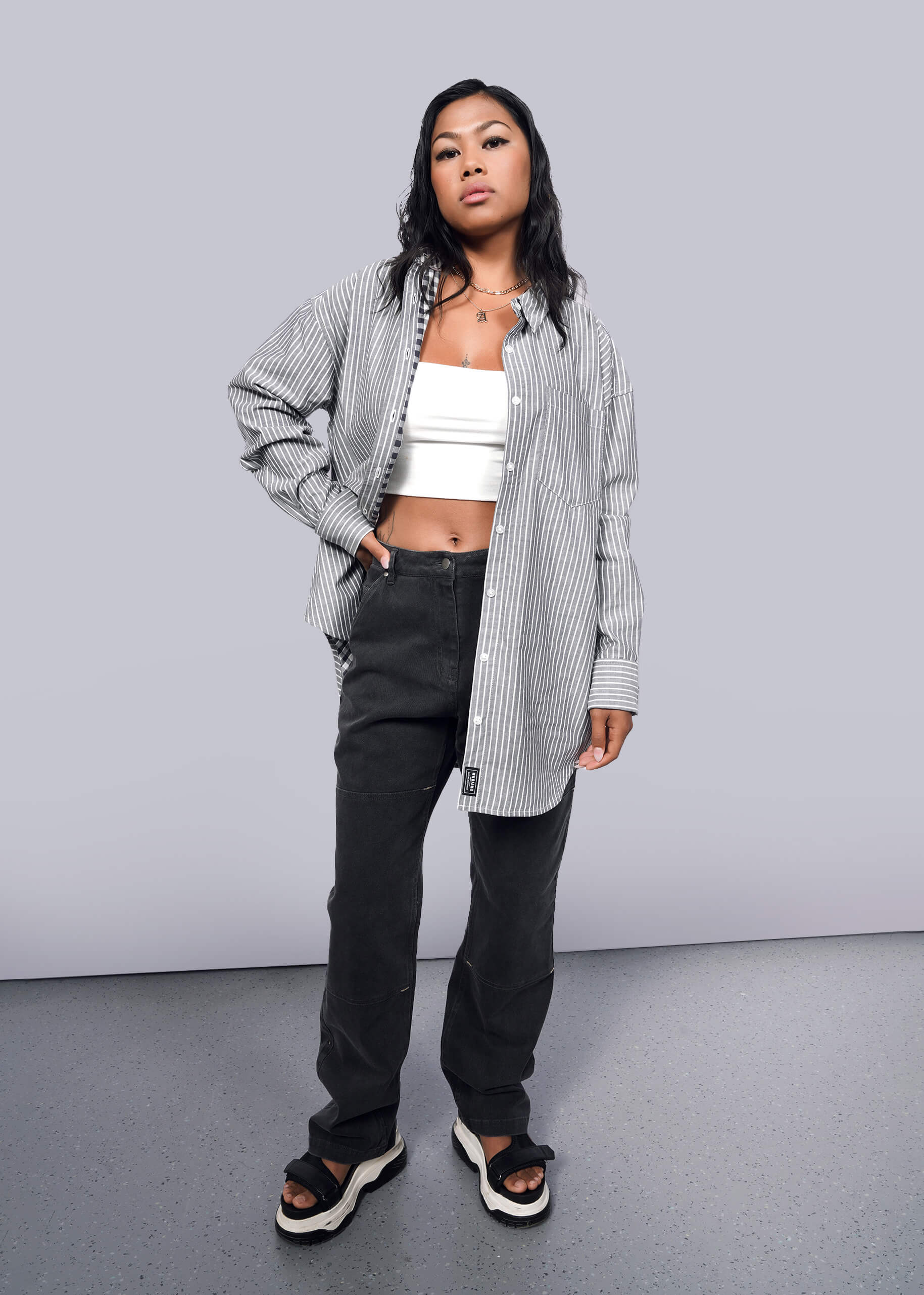 S= Model wearing The Essential Gingham Long Sleeve Oversized Convertible Button Up in Stripe Navy