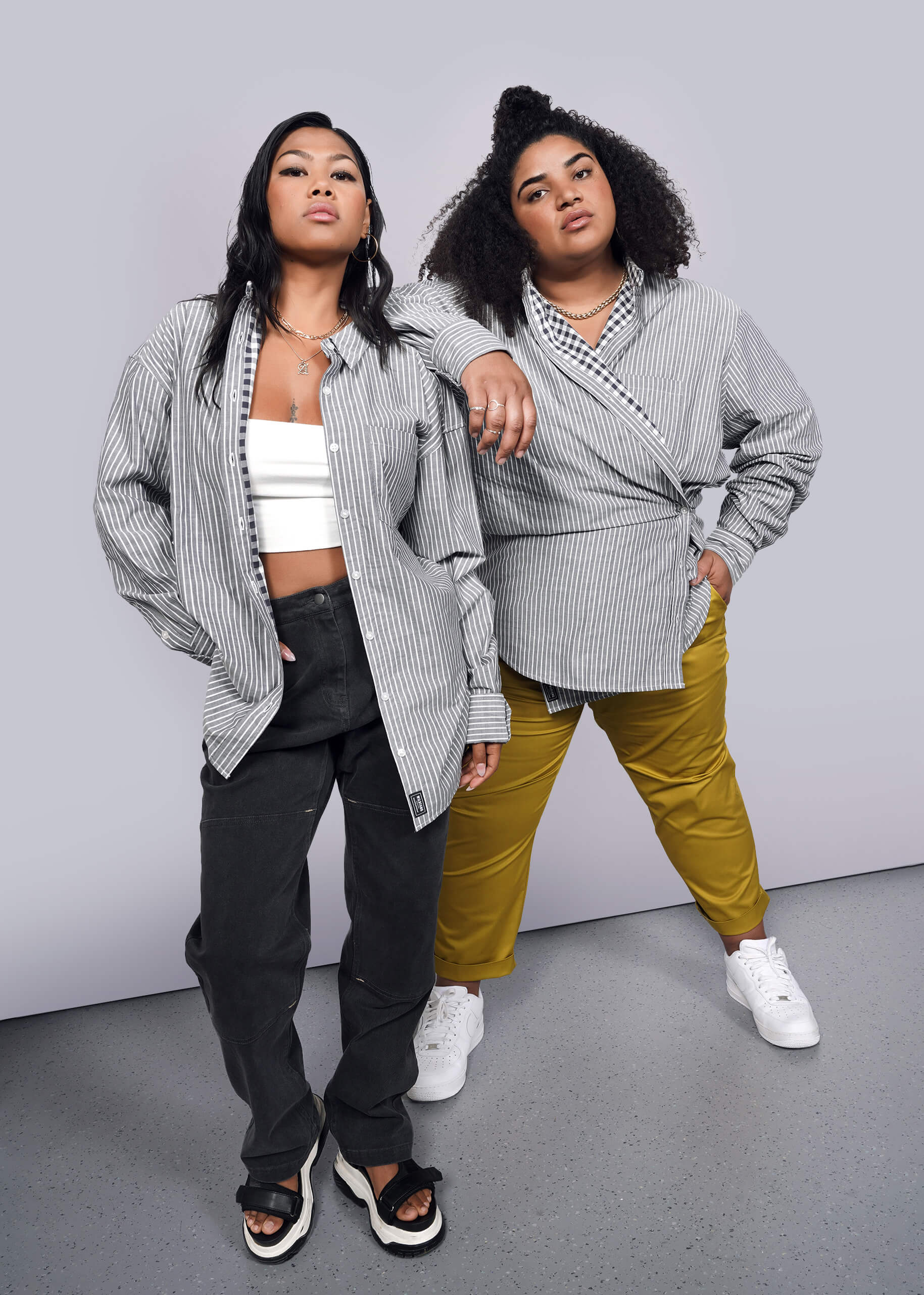 2 Models wearing The Essential Gingham Long Sleeve Oversized Convertible Button Up in Stripe Navy
