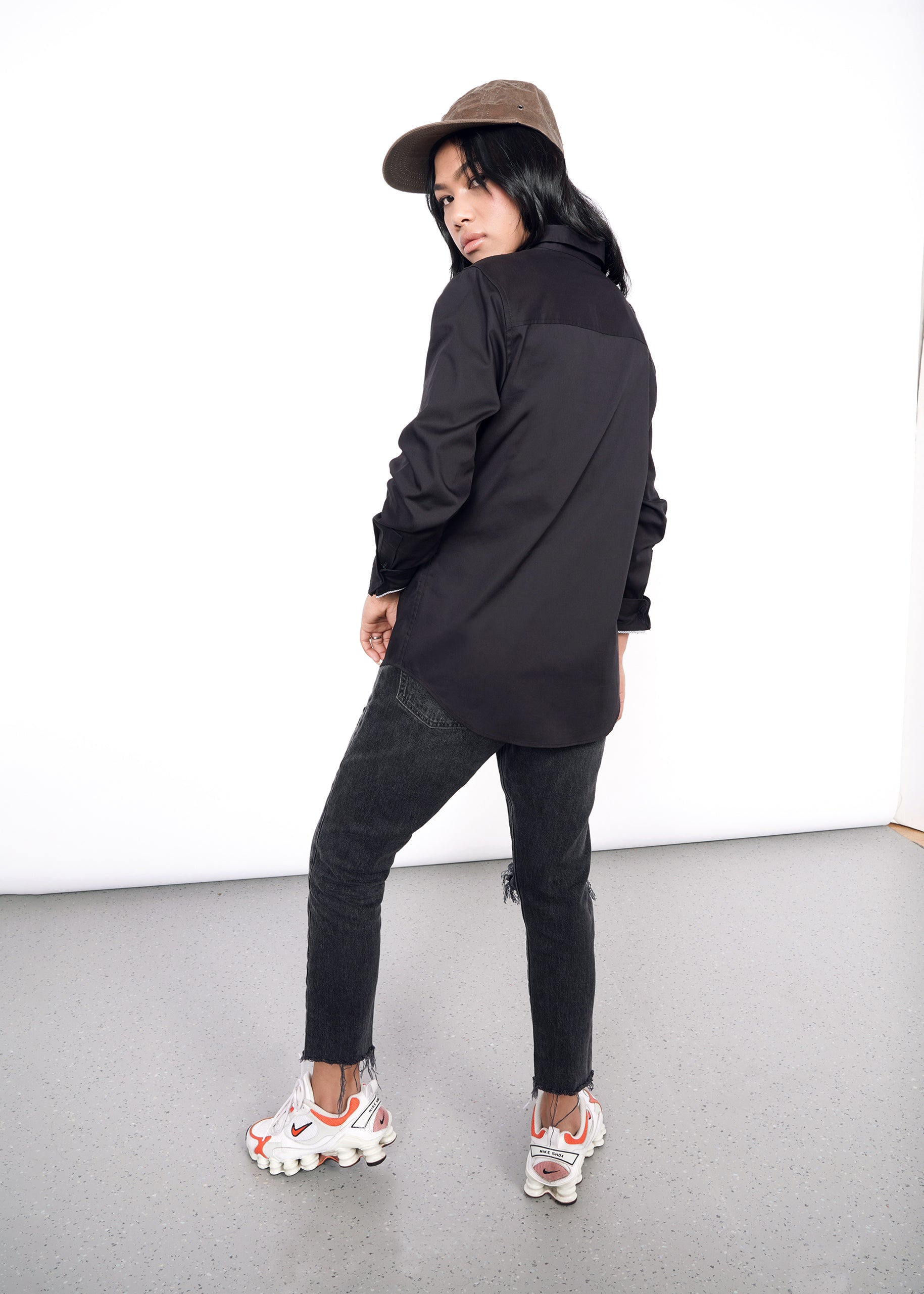 S=Model turned away, wearing black long sleeve button up oxford shirt in size XS