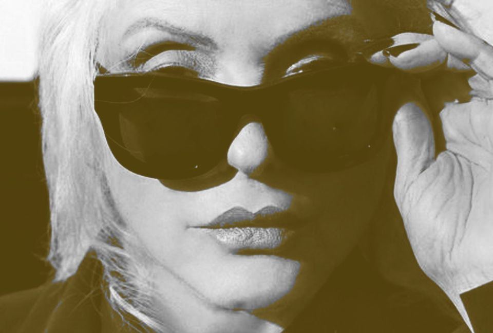 Close up black and white image of Debbie Harry wearing sunglasses