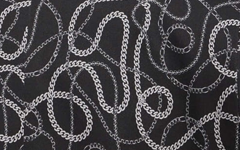 Close up image of grey, white, and black chain print from Debbie Harry x Wildfang collection