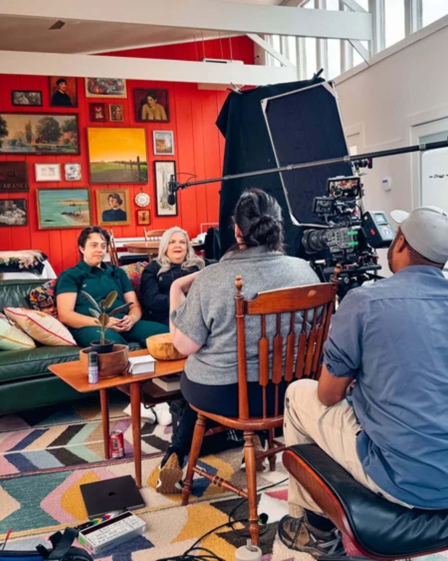 Behind the scenes photograph of a film crew interviewing people.
