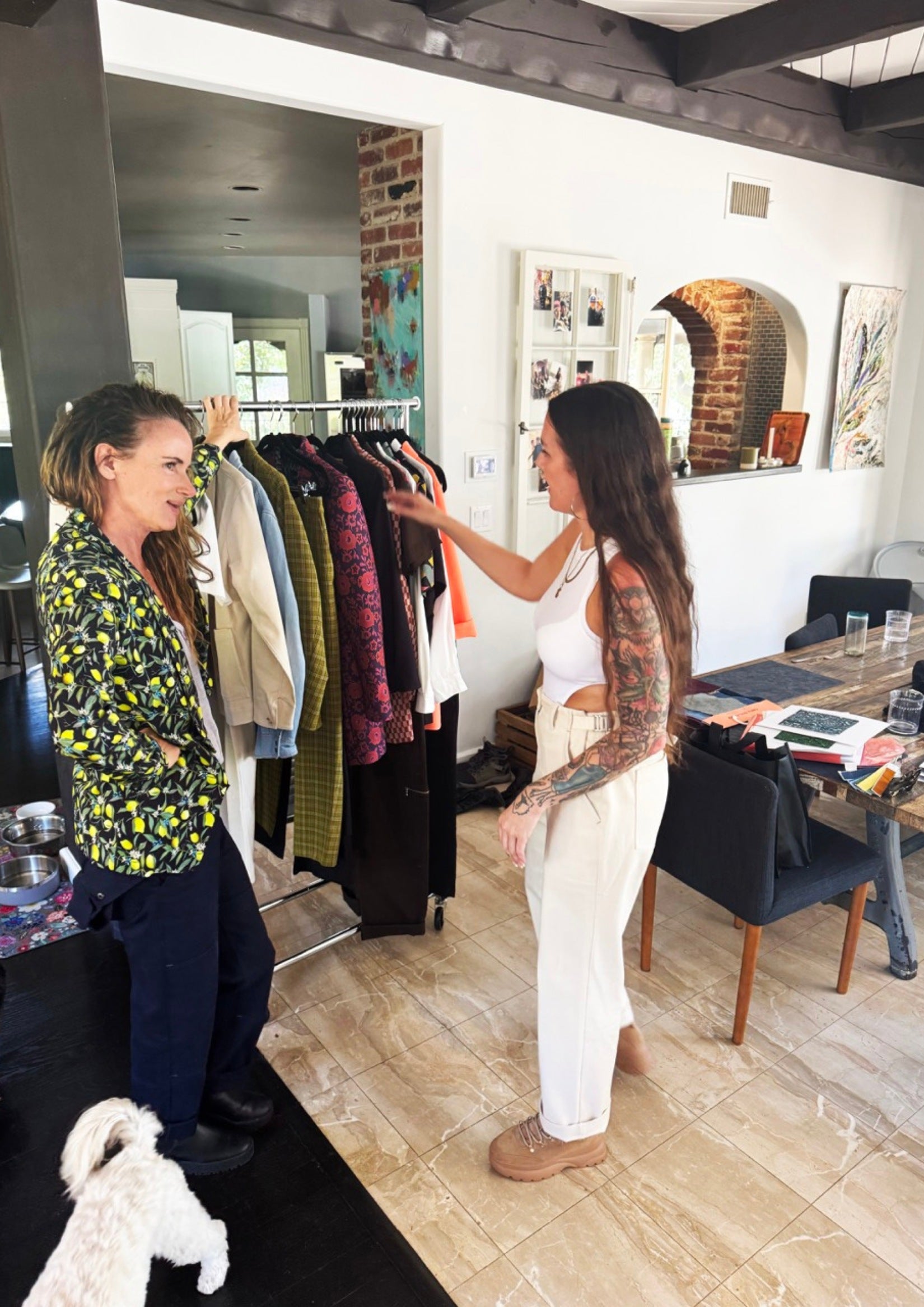 Standing in front of rack of clothes, Juliette Lewis and Tara from Wildfang are pictured chatting.