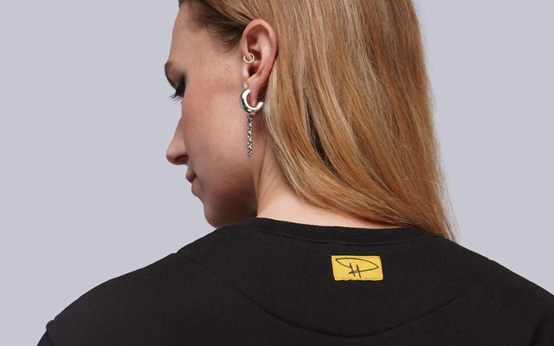 Close up image of Debbie Harry signature label on back of black sweatshirt