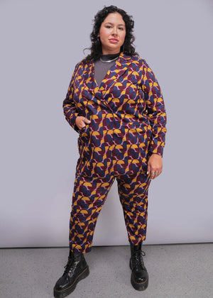 1X=Person wearing a patterned suit with a plain background