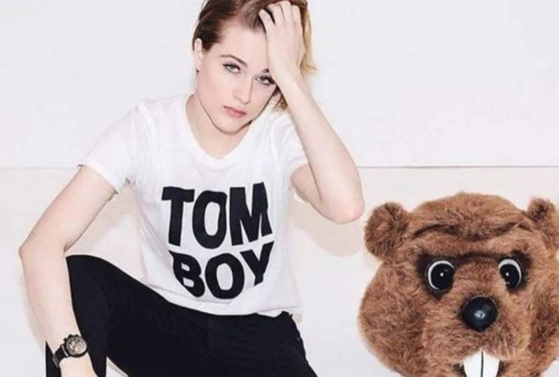 Evan Rachel Wood wears white t shirt that says Tomboy while sitting in front of white wall