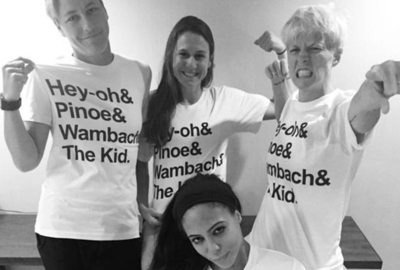 Four members of the US Womens Soccer Team wear matching t shirts