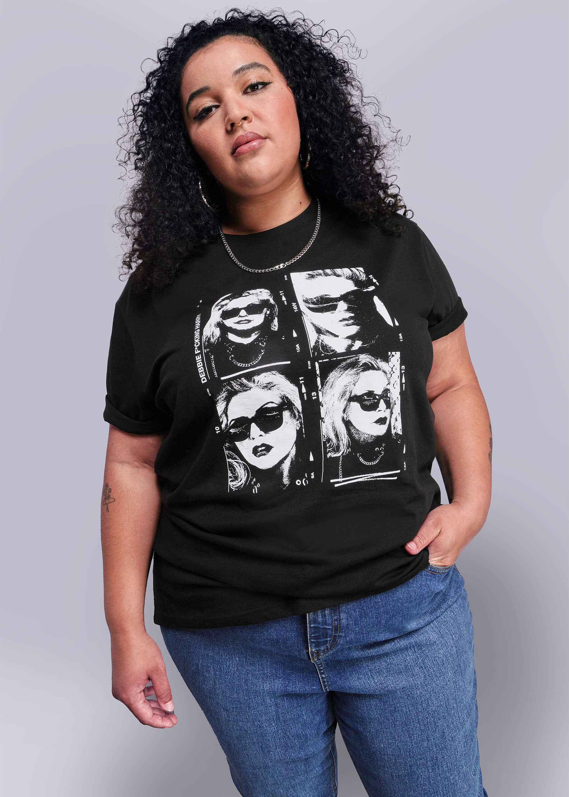 1X=Person wearing a black t-shirt with graphic design on a plain background