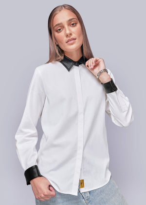S=Person wearing a white shirt with black vegan leather collar and cuffs on a light gray background