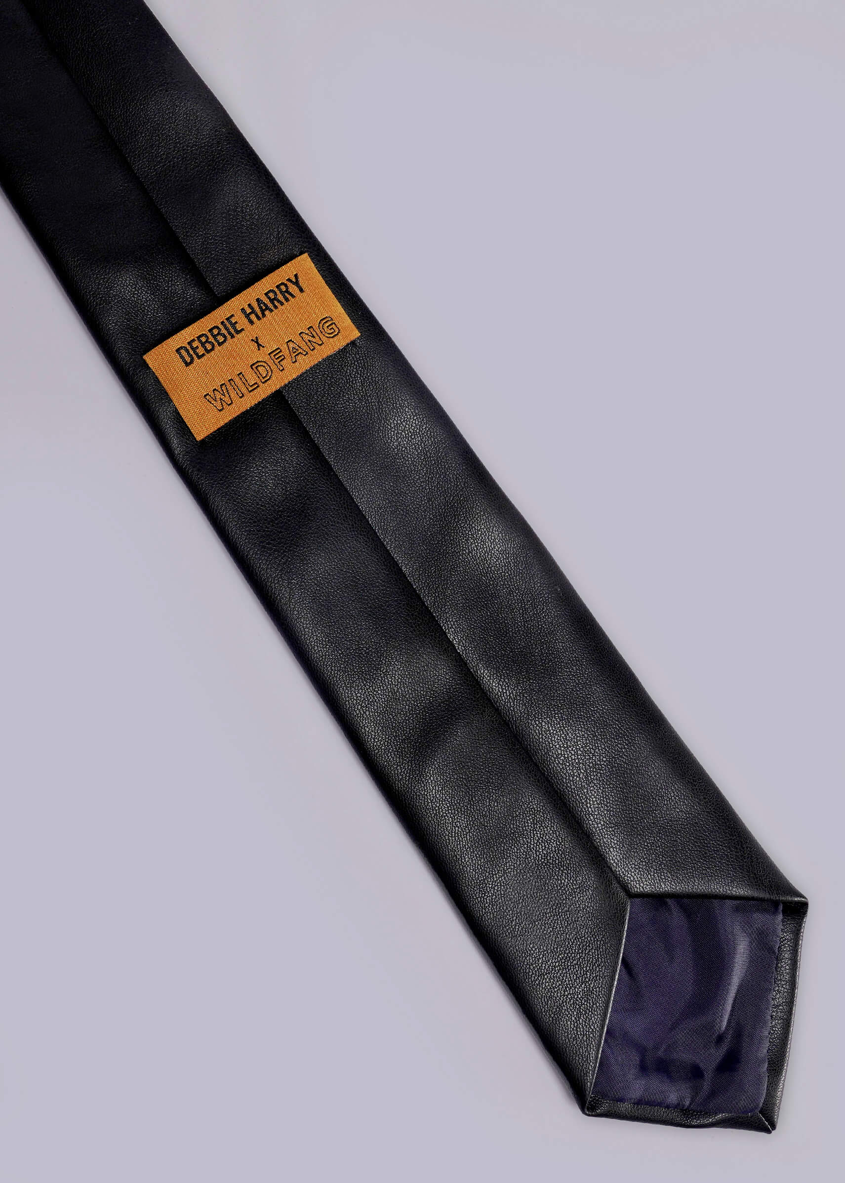 Black tie with a yellow label on a light gray background