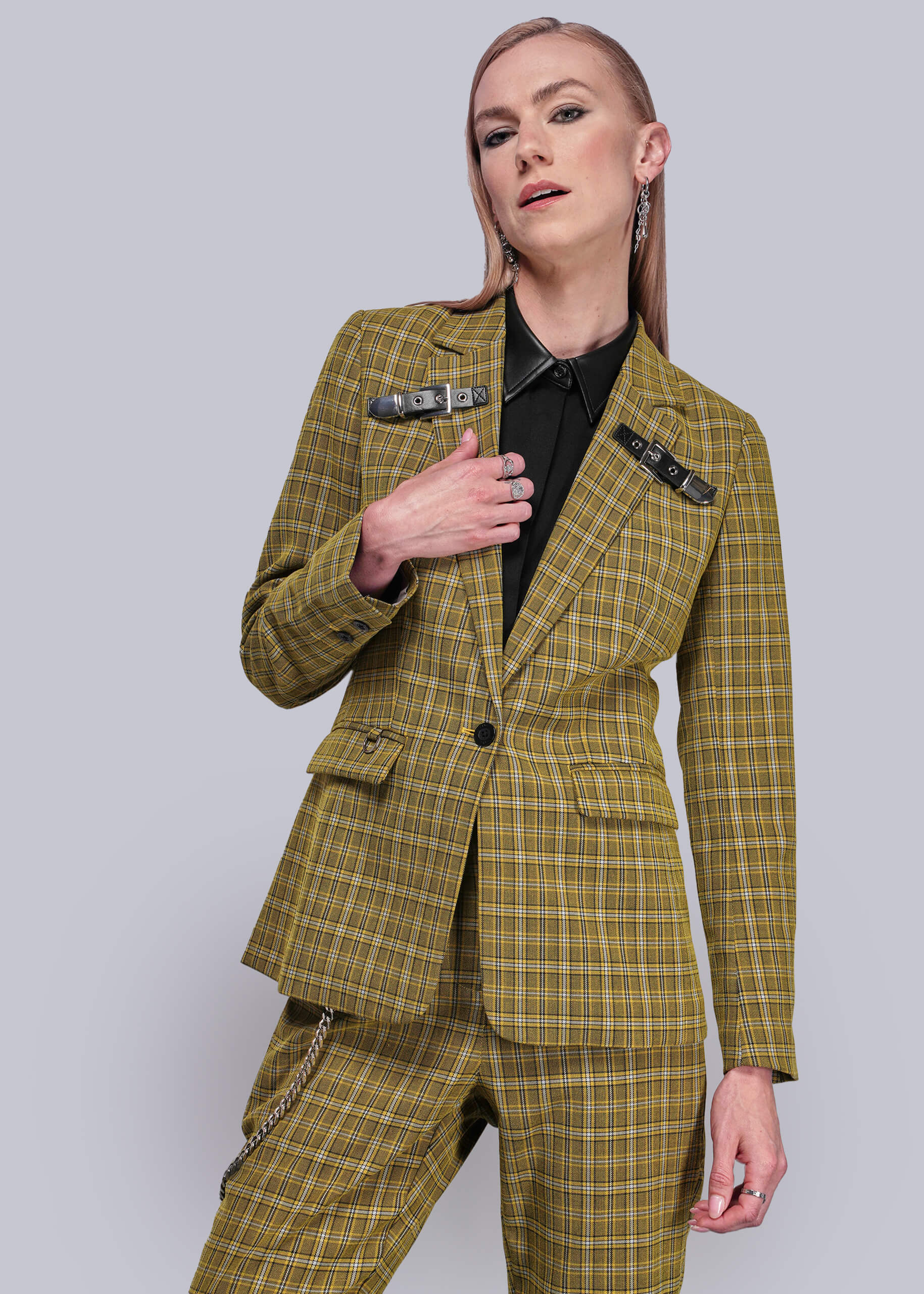 Person wearing a yellow plaid suit against a plain background