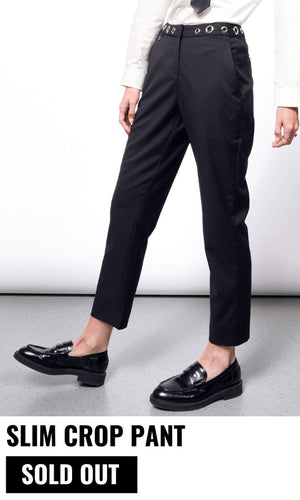 Model pictured from the waist down wearing the black Debbie Harry x Wildfang slim crop pant and black loafers. Text underneath image reads SLIM CROP PANT and button underneath reads SOLD OUT. White background.
