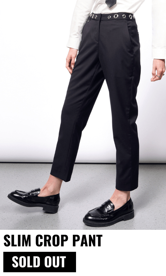 Model pictured from the waist down wearing the black Debbie Harry x Wildfang slim crop pant and black loafers. Text underneath image reads SLIM CROP PANT $138 and button underneath reads SOLD OUT. White background.