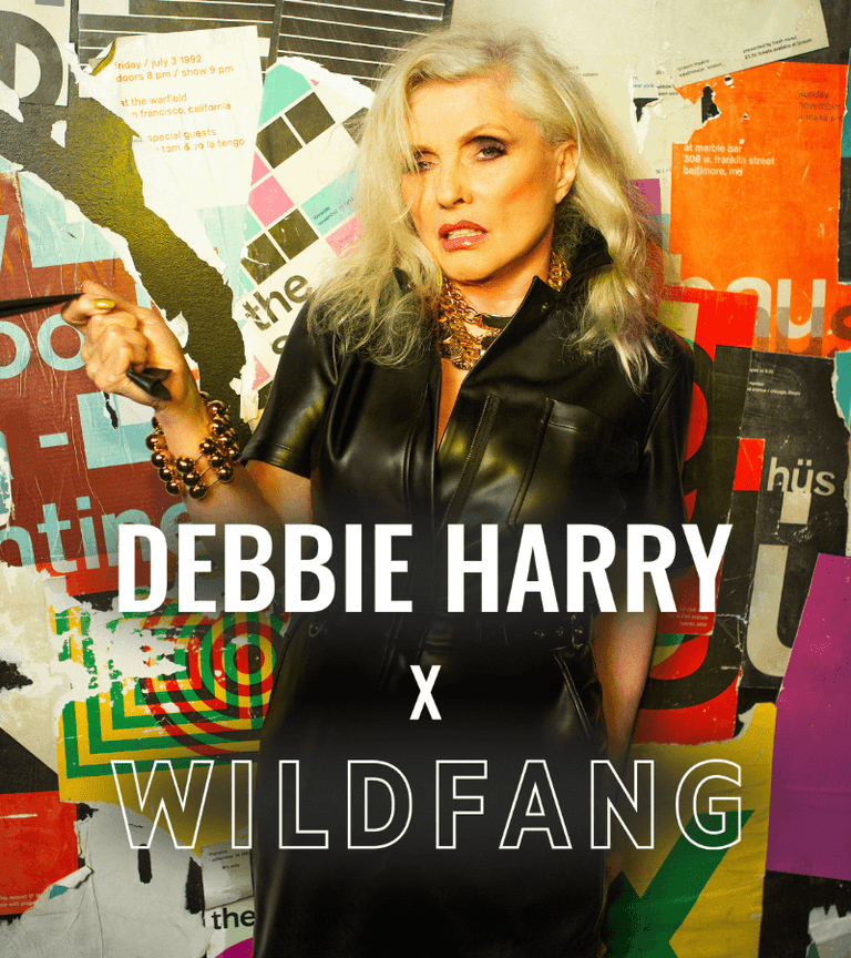 Debbie Harry in front of a colorful collage with 'Debbie Harry x Wildfang' text.