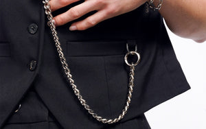 Close up of Debbie Harry x Wildfang Vest showing silver chain connected to u link at pocket.
