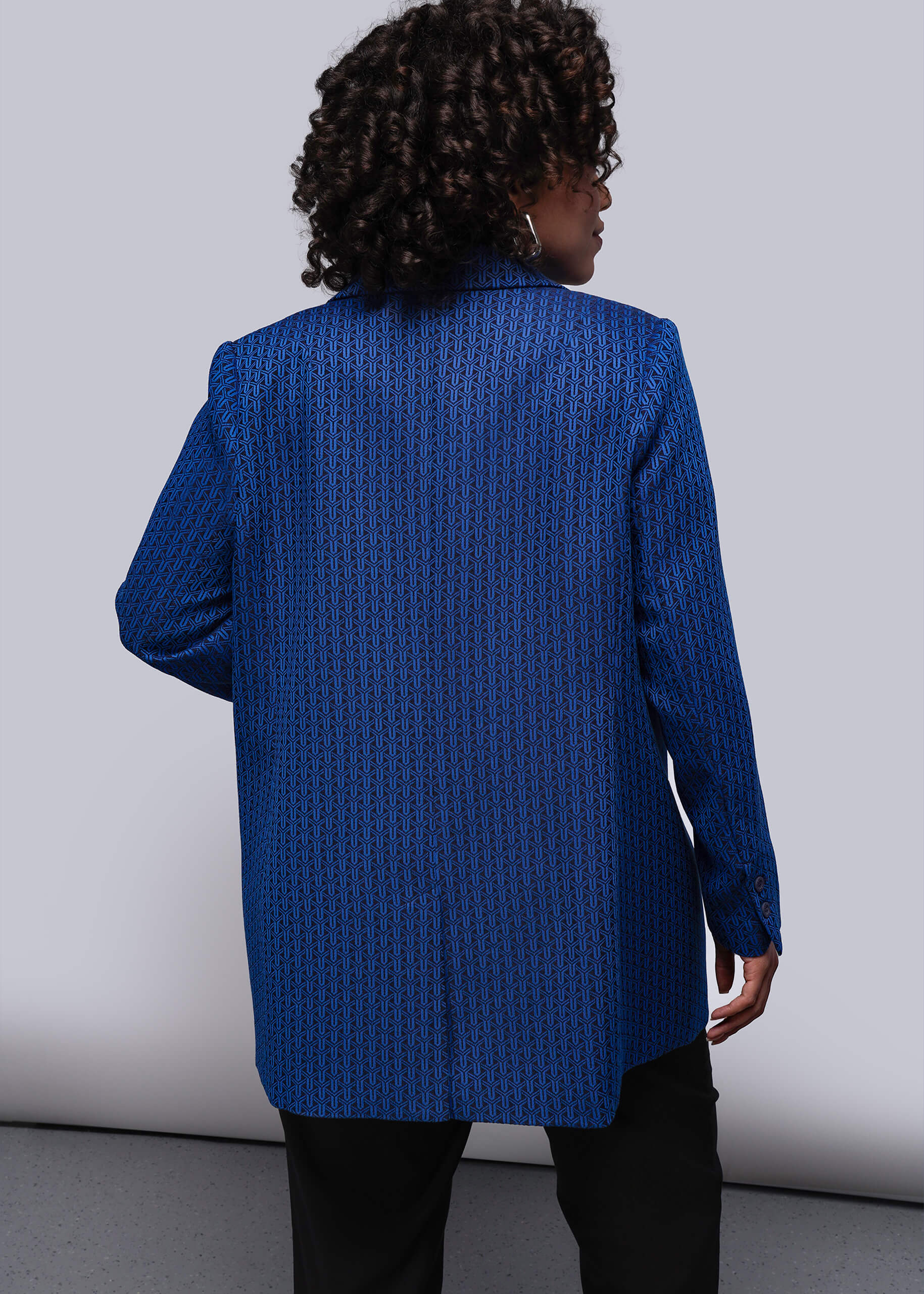 1X=Person wearing a blue textured blazer against a plain background