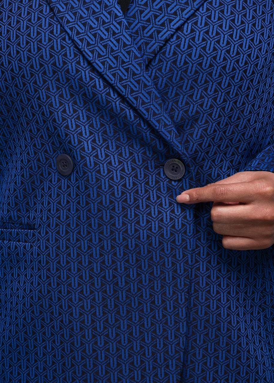 1X=Close up of Blue textured blazer with a hand pointing to a button